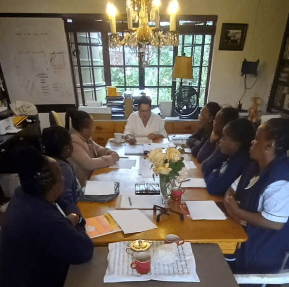 caregivers around the table in the training office for class